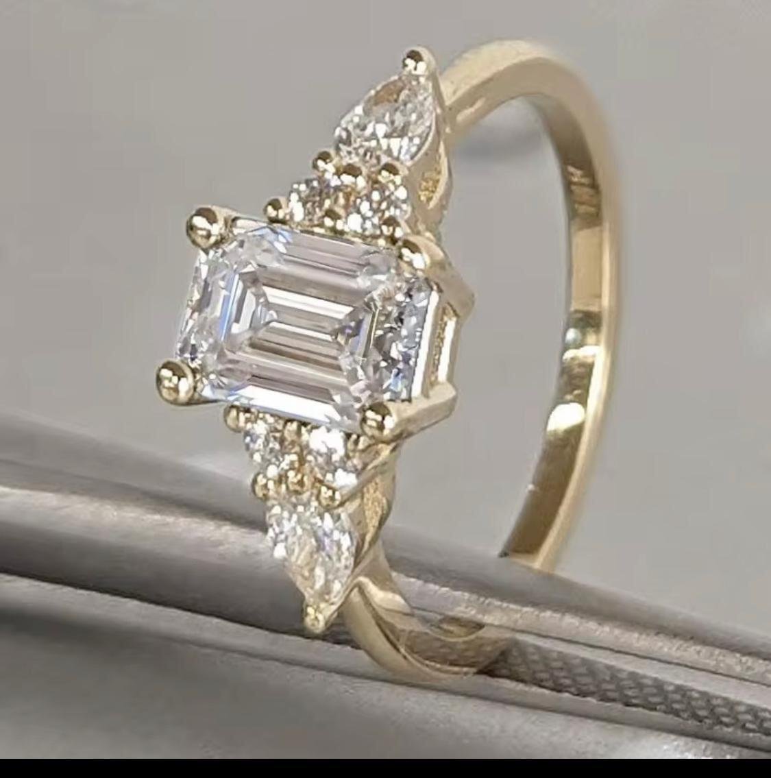 Emerald Cutlabdiamond Engagement Ring With Pear Cut Either Side